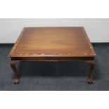 A square mahogany coffee table on claw and ball feet