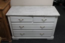 An antique pine painted four drawer chest with marble top