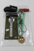 A bag containing Gerber multi tool pocket knife, military cutlery,