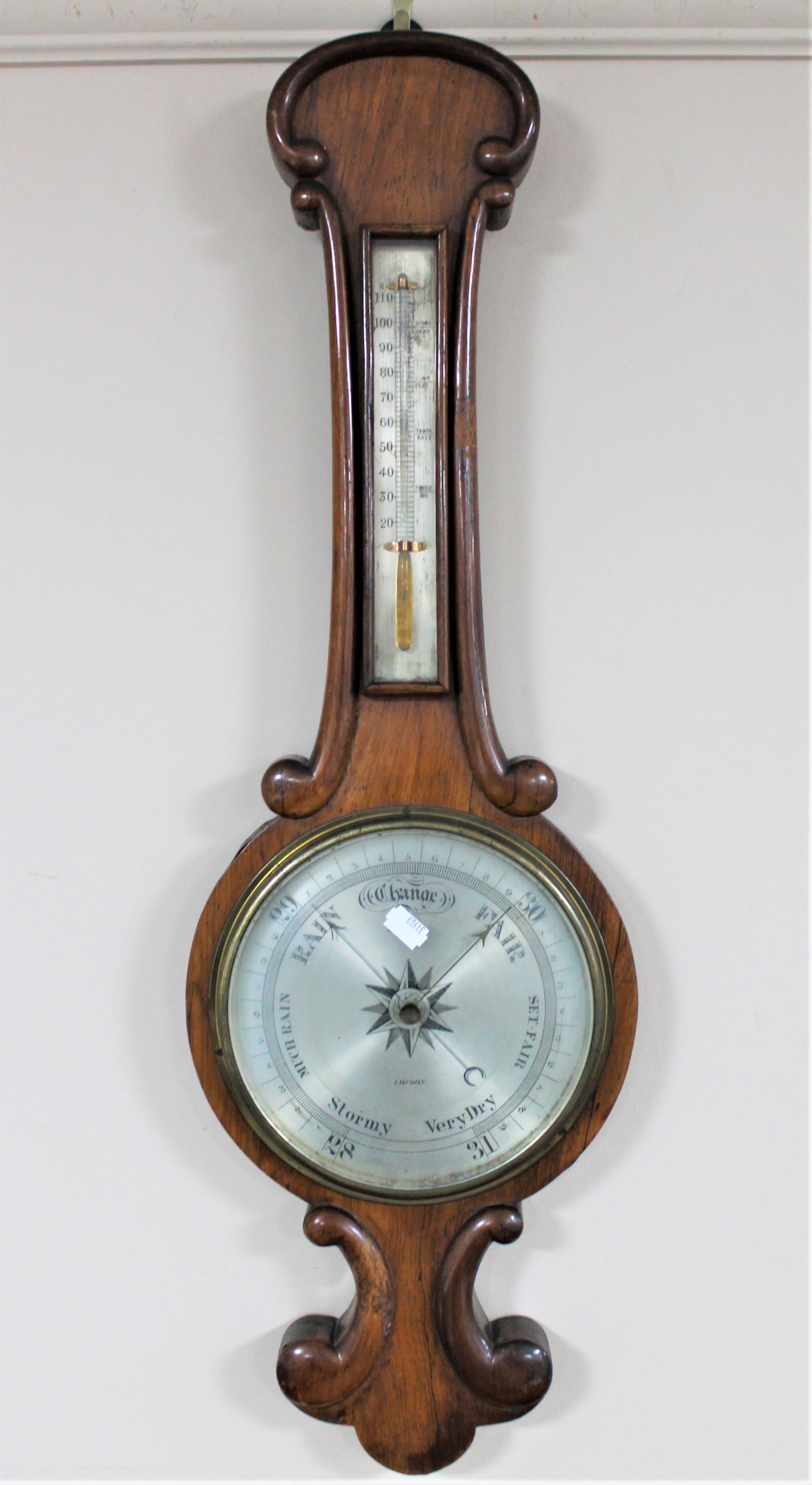 A mahogany cased barometer with silvered dial