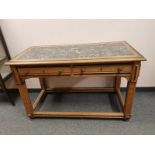 An inlaid oak two drawer side table with granite top,