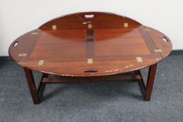 A mahogany butler's tray coffee table on stand