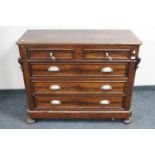 An antique continental mahogany four drawer chest on bun feet