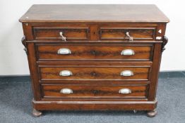An antique continental mahogany four drawer chest on bun feet