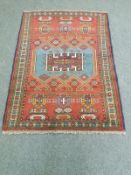 A Caucasian rug on red ground,