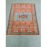 A Caucasian rug on red ground,