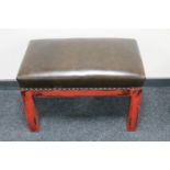 A dressing table stool in brown vinyl