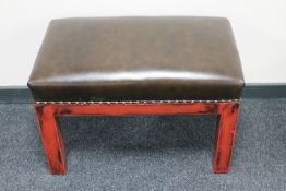 A dressing table stool in brown vinyl