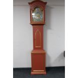 An antique painted longcase clock with brass and silvered dial