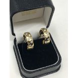 A pair of 18ct gold diamond set earrings, approximately 1.