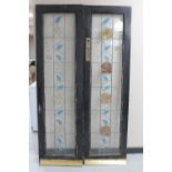 A pair of early twentieth century painted doors with leaded glass panels