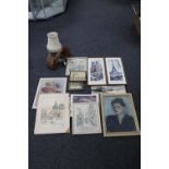 A box of assorted pictures and prints and a tree trunk table lamp