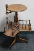 An antique mahogany pedestal wine table with candle sconce and gallery undershelf