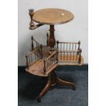 An antique mahogany pedestal wine table with candle sconce and gallery undershelf