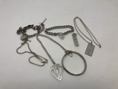 A collection of silver jewellery including ingot pendants,