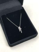 A 10ct white gold diamond spray pendant on chain