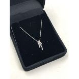 A 10ct white gold diamond spray pendant on chain