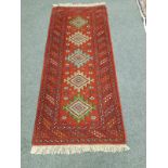 A Caucasian rug on red ground,