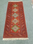 A Caucasian rug on red ground,