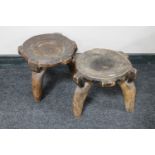 A pair of three legged tribal stools