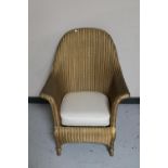 A gold Lloyd Loom basket chair