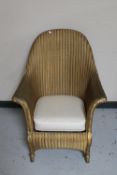 A gold Lloyd Loom basket chair