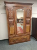 A late Victorian walnut mirror door wardrobe,