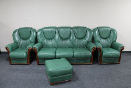 A three piece green leather lounge suite with matching footstool