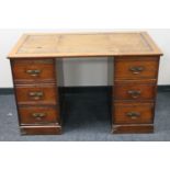 An Edwardian oak twin pedestal desk by Robsons on Newcastle