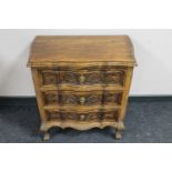 A shaped beech wood three drawer chest