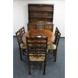 An oval oak farmhouse kitchen table and six ladder back chairs