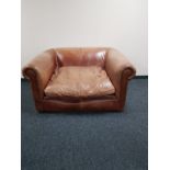 A tan leather oversized armchair