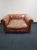 A tan leather oversized armchair