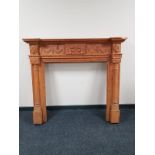 A heavily carved pine fire surround CONDITION REPORT: 124cm high by 140cm wide by