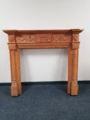 A heavily carved pine fire surround CONDITION REPORT: 124cm high by 140cm wide by