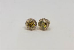 A pair of 14ct gold yellow diamond stud earrings,