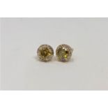 A pair of 14ct gold yellow diamond stud earrings,
