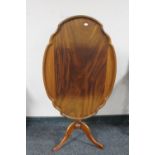 An antique mahogany tilt topped occasional table