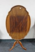 An antique mahogany tilt topped occasional table