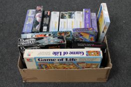 A box of assorted jigsaws and board games