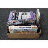 A box of assorted jigsaws and board games