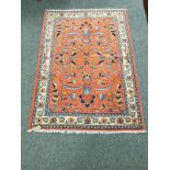 A Malayer rug, on salmon ground,