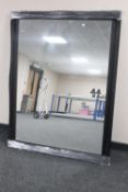 A black framed overmantel mirror