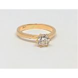 An 18ct gold solitaire diamond ring, the brilliant-cut stone weighing approximately 0.