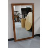 A large teak framed overmantel mirror