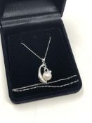 A 14ct white gold pearl and diamond pendant on chain