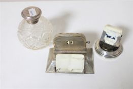 Two early 20th century silver desk calendars together with a silver lidded cut glass perfume bottle