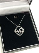 A 10ct gold diamond set pendant on chain