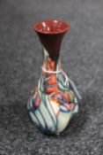 A Moorcroft pottery vase of baluster form with floral decoration, height 17 cm.