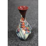 A Moorcroft pottery vase of baluster form with floral decoration, height 17 cm.